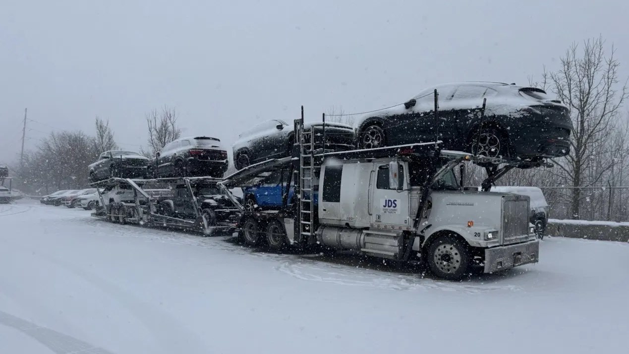 A loaded JDS car carrier working through heavy snow
